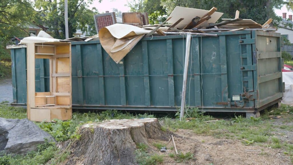 Dumpster with roof debris