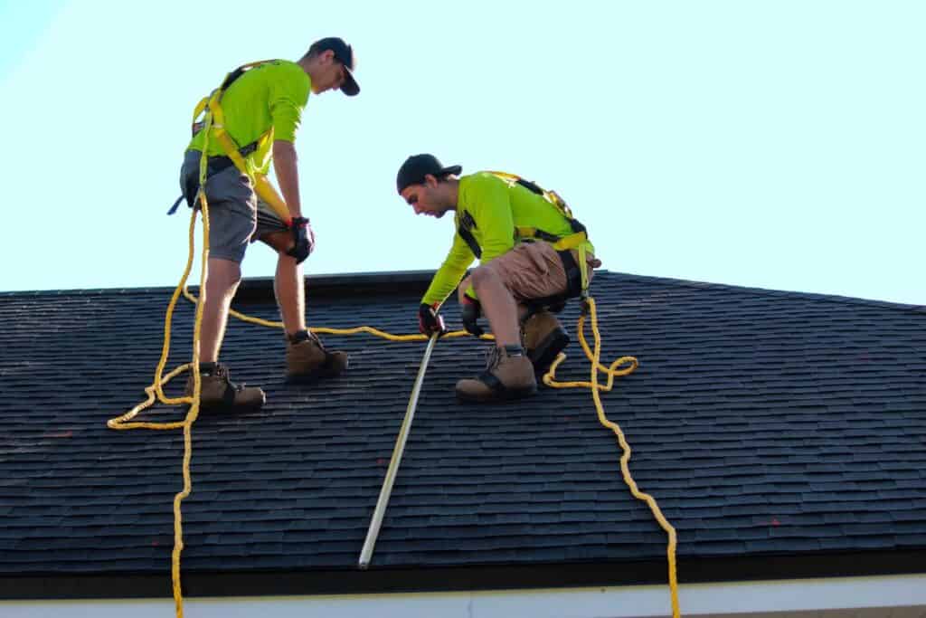 Two men installing a roof